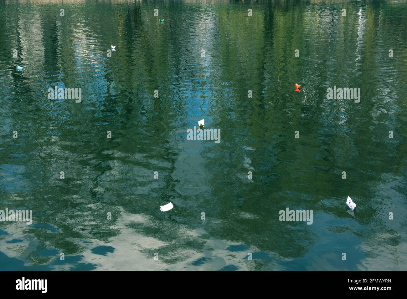 Many paper boats float on the water. Origami Stock Photo - Alamy