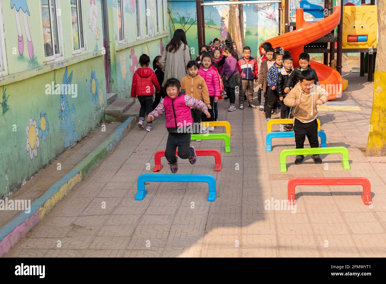 Kindergarten students playing a rural school in Qufu, Shandong, China. Stock Photo