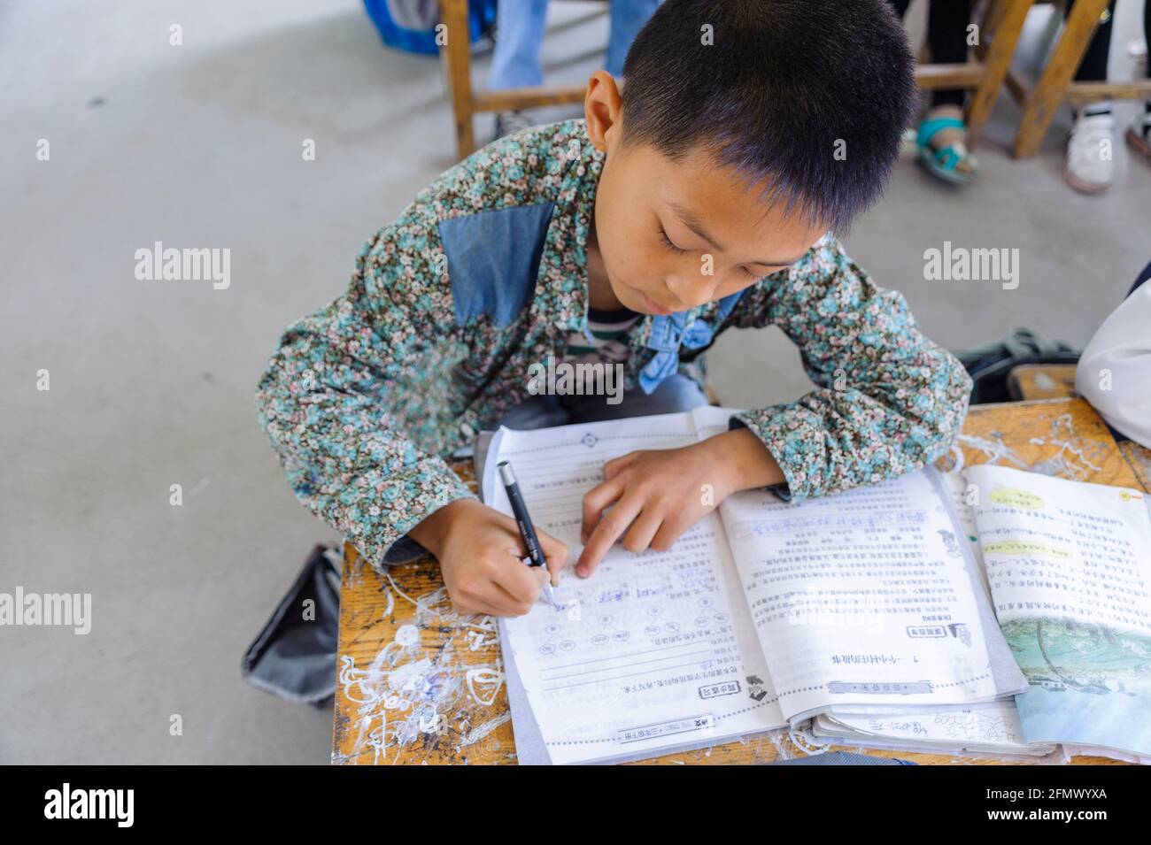 A Chinese student in a rural school in Qufu, Shandong, China doing his Chinese lesson. Stock Photo