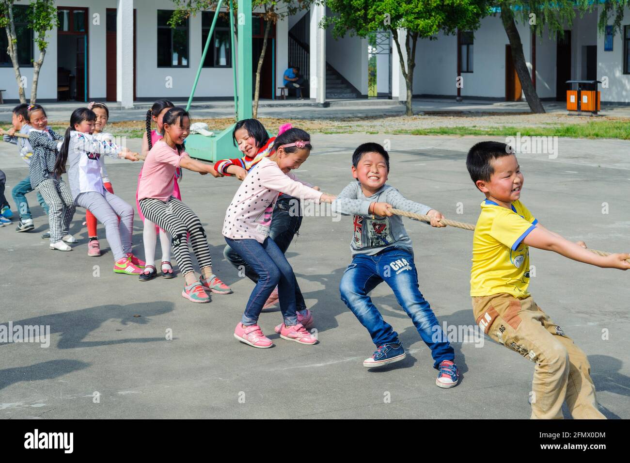 Students from Weiqiao Central Primary school of Xiuning, Anhui, China participate in a tug-of-war competition. Stock Photo
