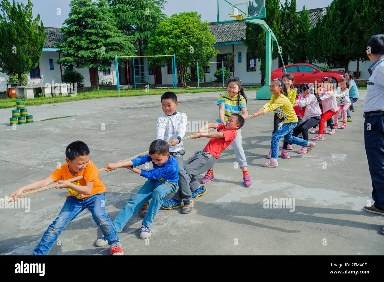Students from Weiqiao Central Primary school of Xiuning, Anhui, China participate in a tug-of-war competition. Stock Photo