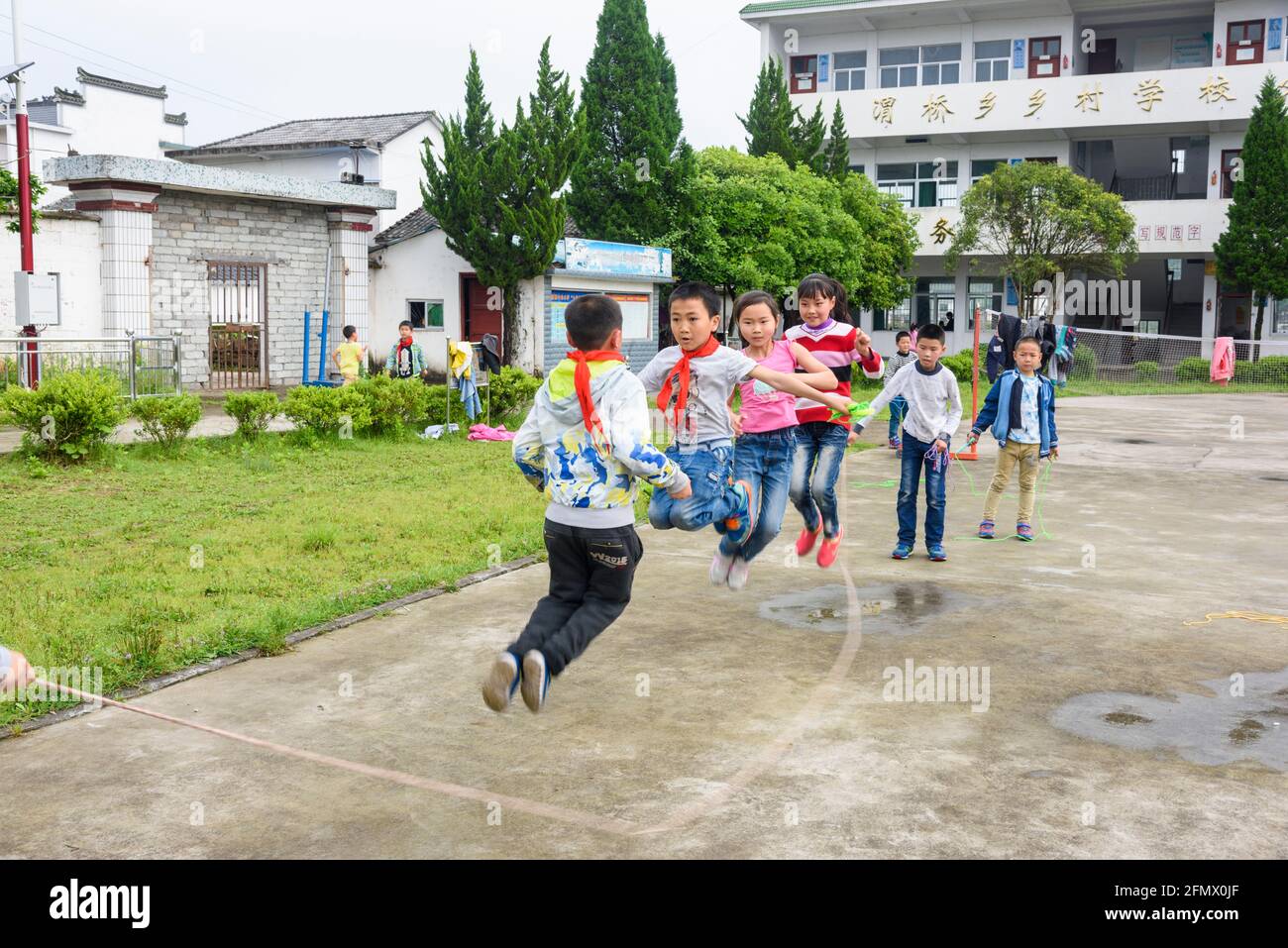 Student at a rural primary school jump rope during their recess time. Stock Photo
