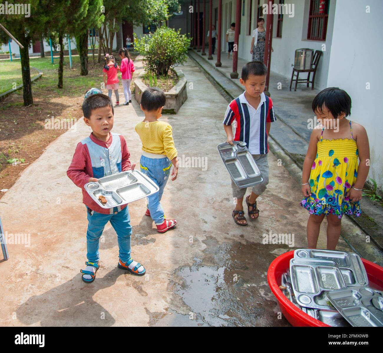 Student lining up for lunch and returning lunch plates in a rural school in Xiuning, Anhui, China Stock Photo