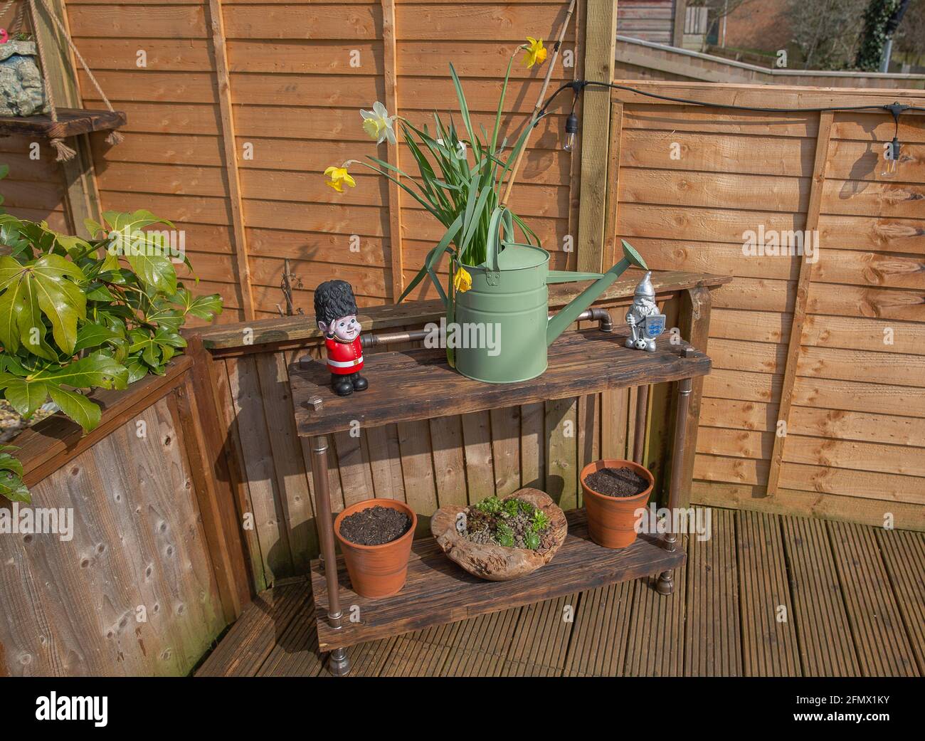 Garden shelving unit made from reclaimed wood and industrial piping