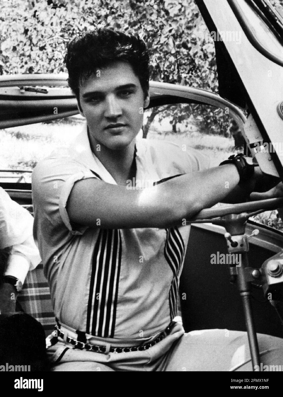 Presley, Elvis, 8.1.1935 - 16.8.1977, American singer and actor, half length, sitting in car, 1950s, ADDITIONAL-RIGHTS-CLEARANCE-INFO-NOT-AVAILABLE Stock Photo