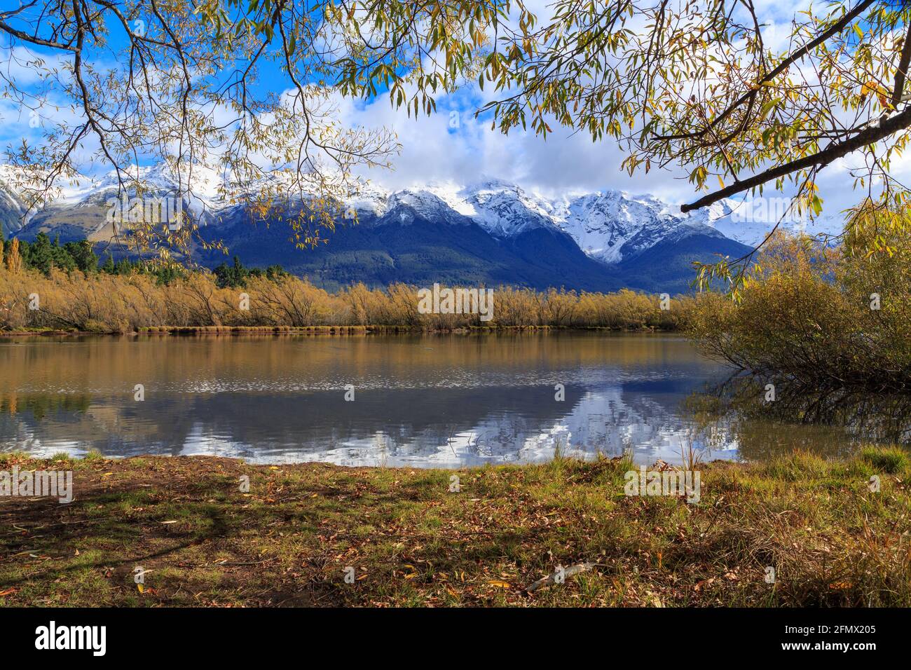 The Glenorchy Lagoon, a beautiful wetland near Glenorchy, New Zealand, surrounded by autumn willows with the Southern Alps in the background Stock Photo
