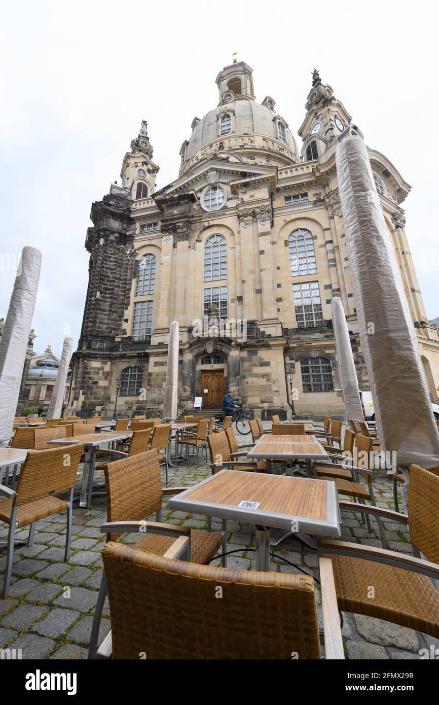 Dresden, Germany. 12th May, 2021. Sunshades of a restaurant are folded up and covered with protective hoods on the Neumarkt in front of the Frauenkirche. Credit: Robert Michael/dpa-Zentralbild/dpa/Alamy Live News Stock Photo