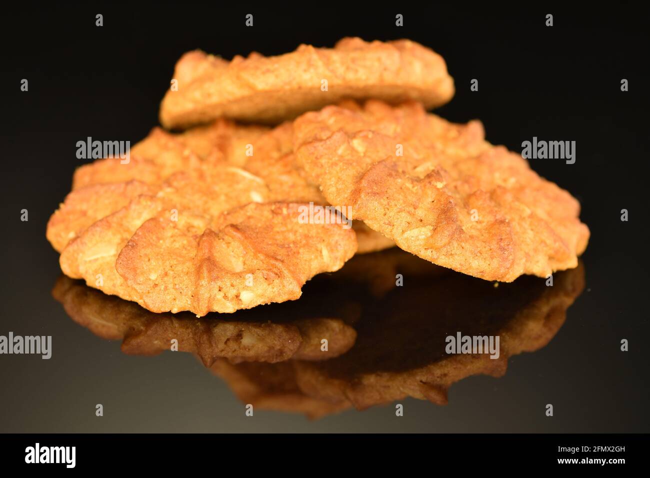 Several fragrant, crispy cereal cookies, close-up, on a black background. Stock Photo