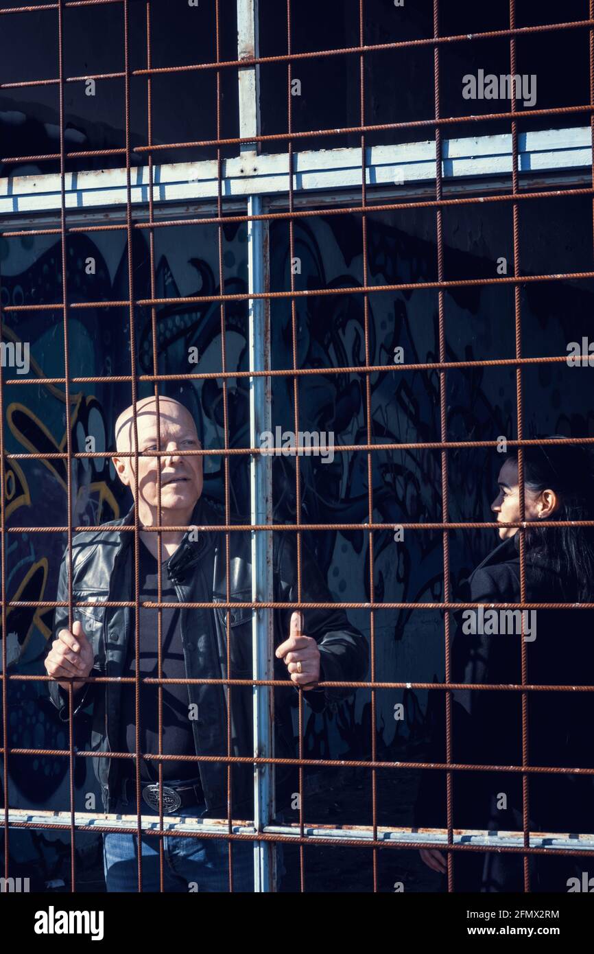 man and woman locked in cage at an abandoned building Stock Photo - Alamy