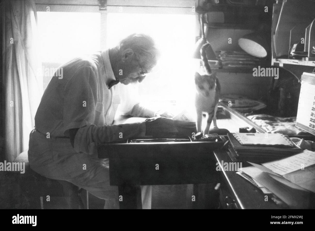 Schweitzer, Albert, 14.1.1875 - 4.9.1965, German medic / physicist, half length, sitting at his desk, ADDITIONAL-RIGHTS-CLEARANCE-INFO-NOT-AVAILABLE Stock Photo