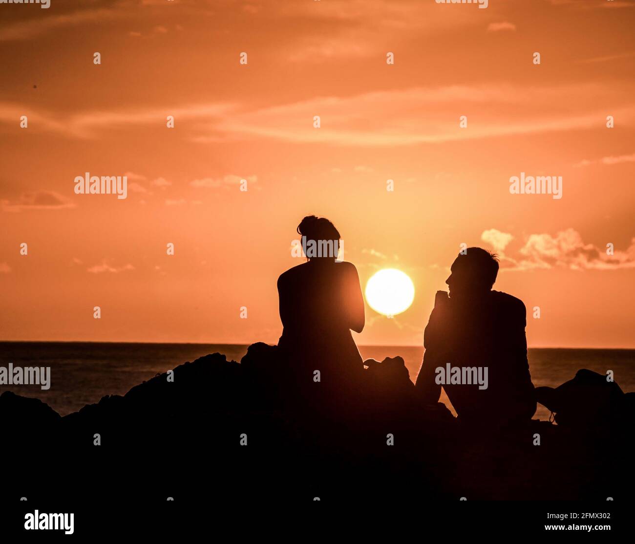 Silhouettes young couple admiring sunset hi-res stock photography and ...