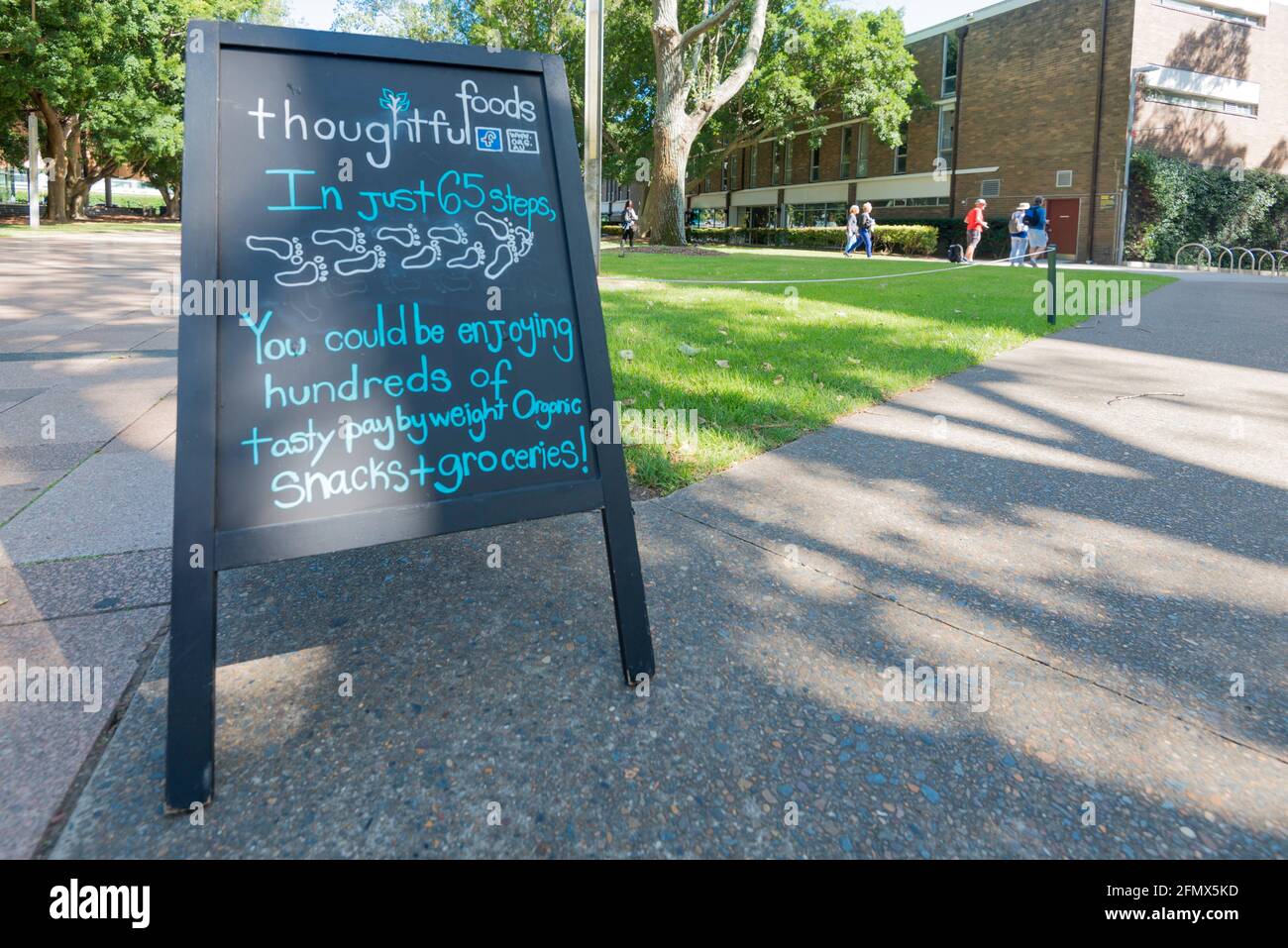 A chalkboard sign at the University of New South Wales in Sydney, Australia advertises organic food and groceries Stock Photo