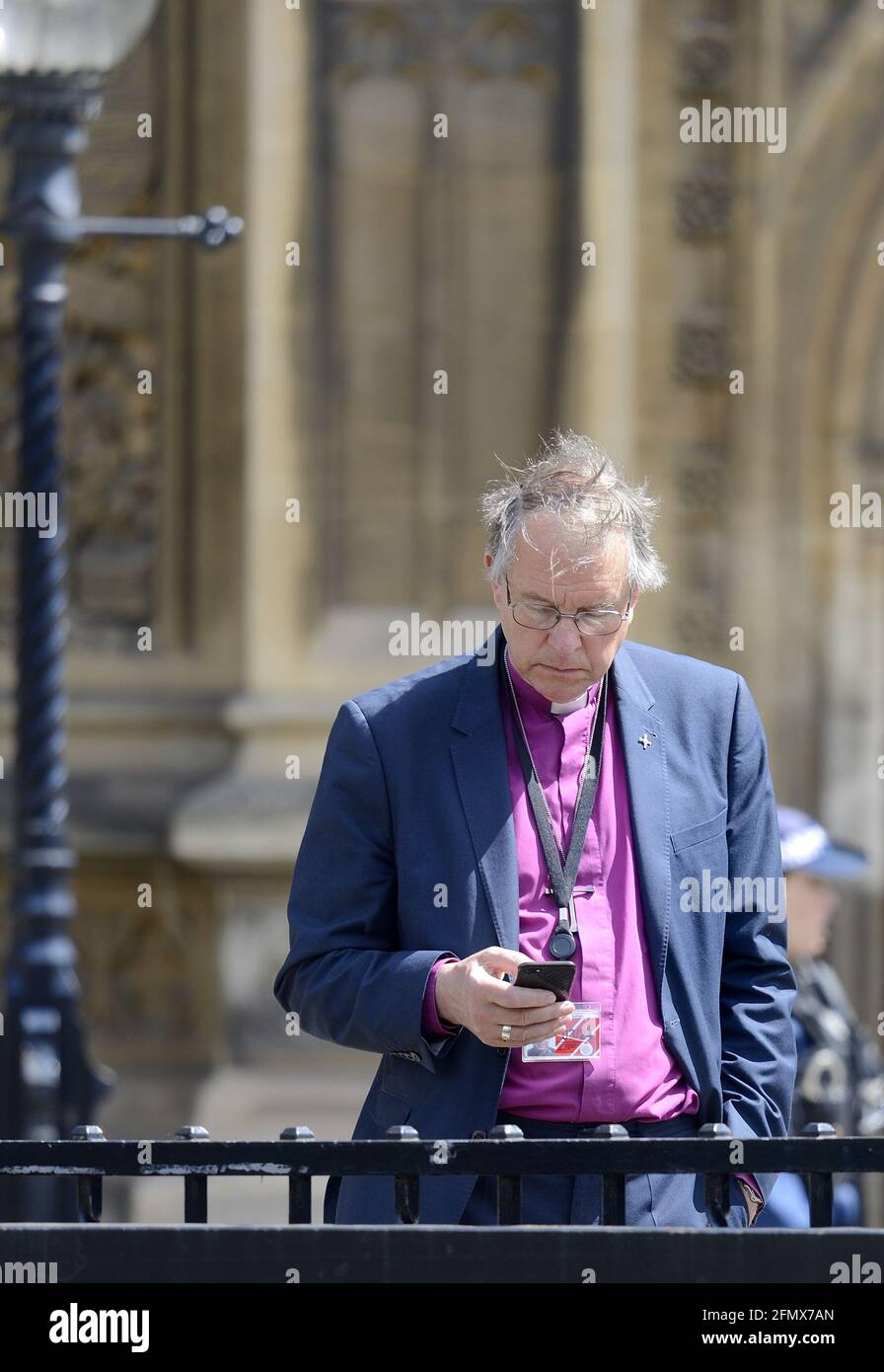 The Right Reverend Paul Butler, Bishop of Durham on his mobile phone outside Parliament after the Queen's Speech at the State Opening, 11th May 2021 Stock Photo