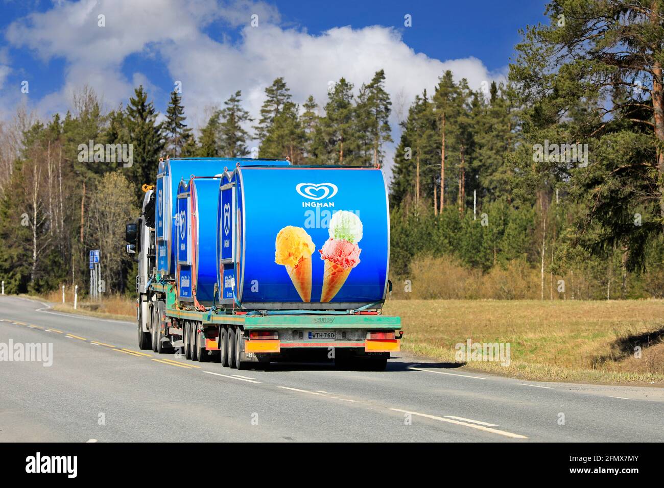 Mercedes-Benz Actros truck hauling three Ingman ice cream kiosks on semi trailer on a sunny day of spring. Highway 2, Forssa, Finland. April 29, 2021. Stock Photo