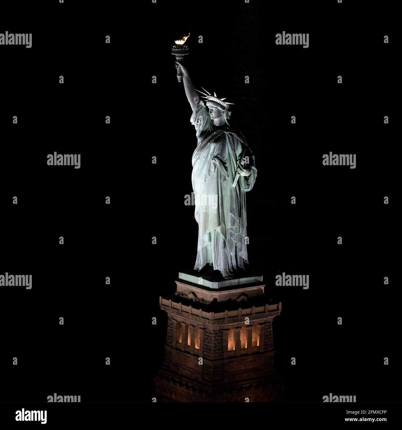 An aerial shot of the Statue of Liberty at night, New York City, New York, United States of America Stock Photo