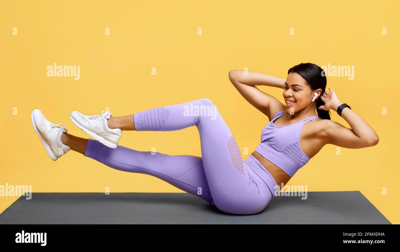 Sport and fitness concept. Young black woman doing bicycle crunch abs