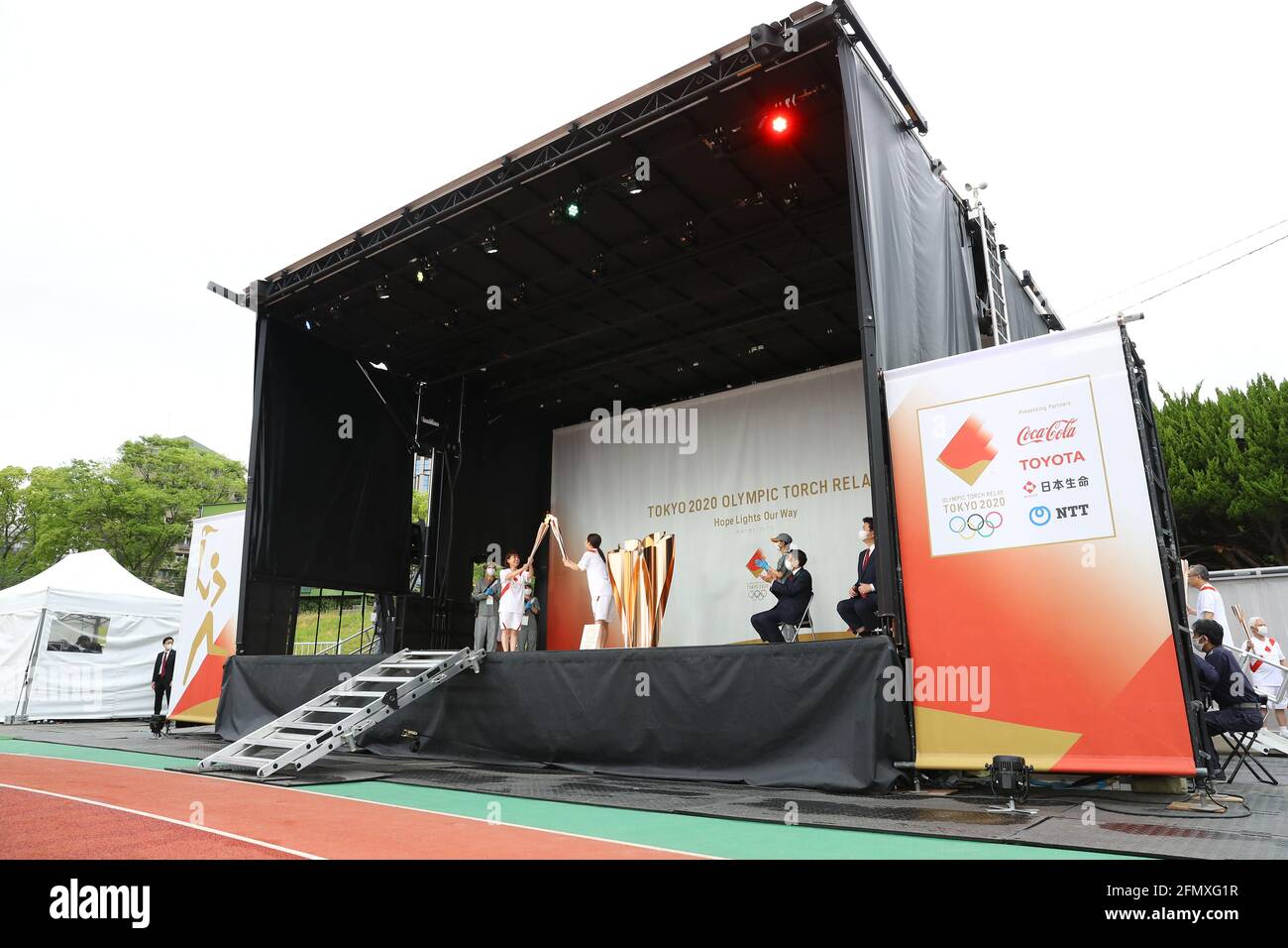 (210512) -- FUKUOKA, May 12, 2021 (Xinhua) -- An ignition ceremony for the Tokyo Olympic torch relay is held at Heiwadai Athletic Stadium in Fukuoka, southwestern Japan, May 11, 2021. The torch relay was taken off public roads and replaced by ignition ceremony due to the coronavirus pandemic. (Tokyo2020/Handout via Xinhua) Stock Photo