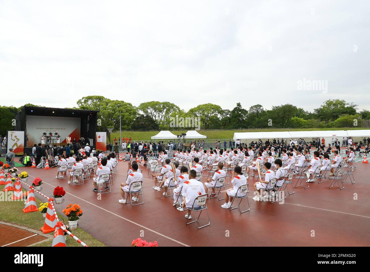 (210512) -- FUKUOKA, May 12, 2021 (Xinhua) -- An ignition ceremony for the Tokyo Olympic torch relay is held at Heiwadai Athletic Stadium in Fukuoka, southwestern Japan, May 11, 2021. The torch relay was taken off public roads and replaced by ignition ceremony due to the coronavirus pandemic. (Tokyo2020/Handout via Xinhua) Stock Photo