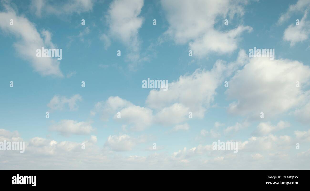 Blue sky with white fluffy clouds Stock Photo - Alamy