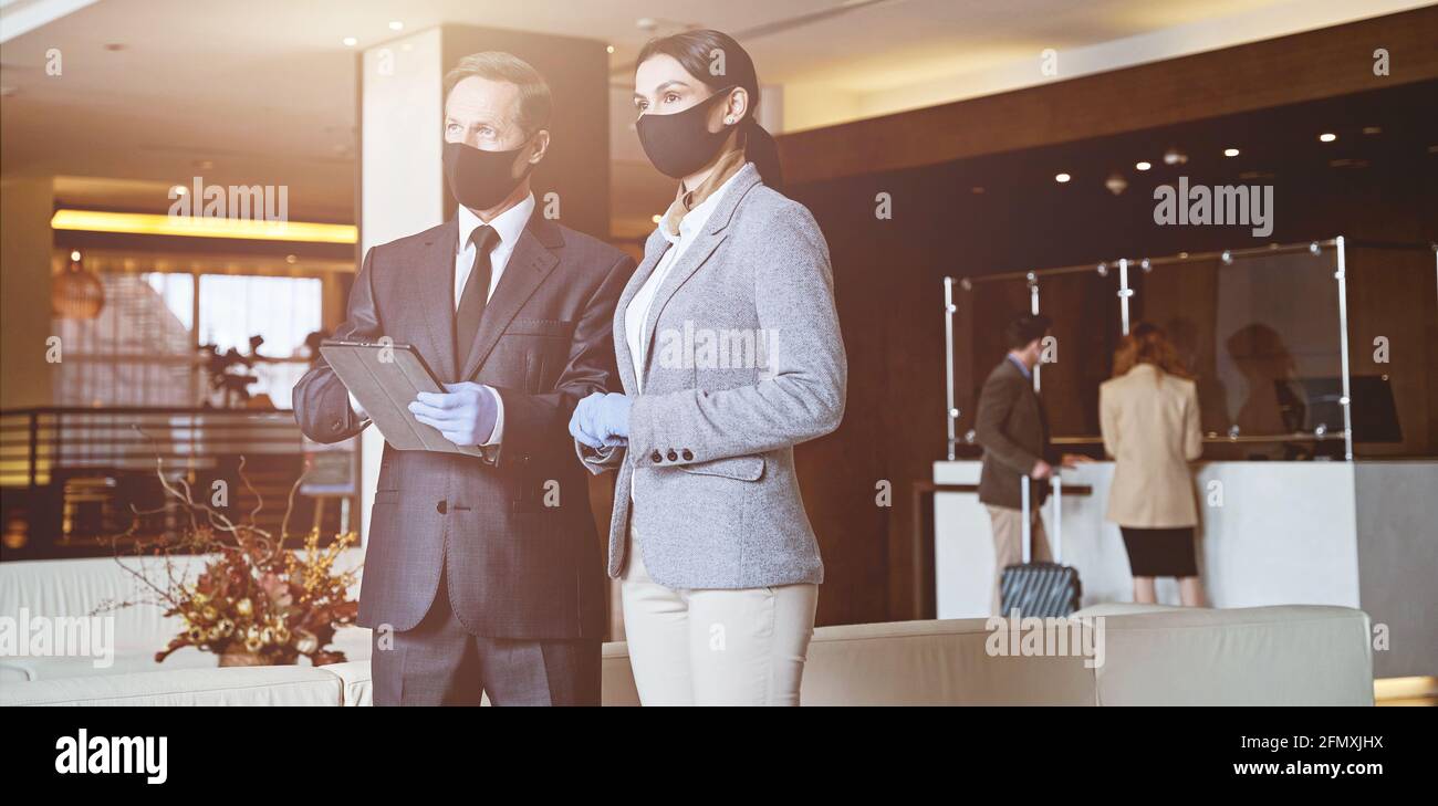 Hotel receptionists looking at the arriving guests Stock Photo Alamy