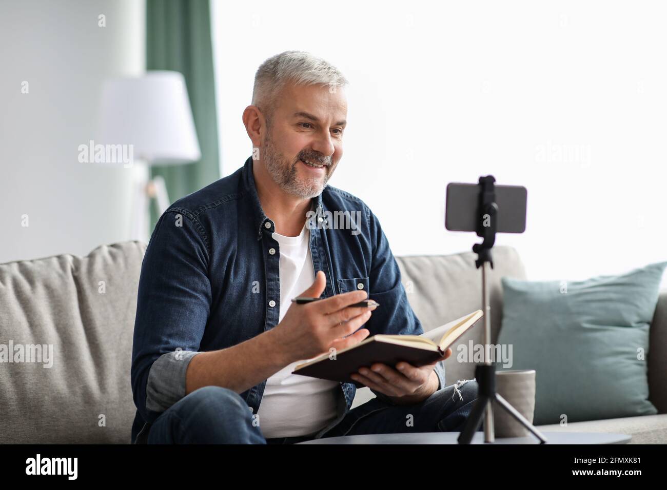Happy elderly man studying online while staying home Stock Photo