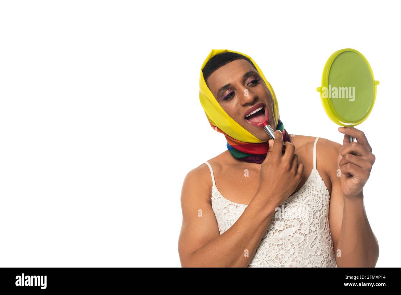 african american transgender man in dress and lgbt colors head kerchief applying lipstick isolated on white Stock Photo
