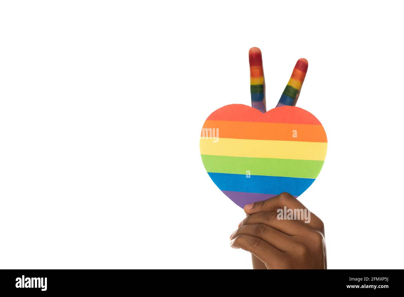cropped view of african american man showing victory gesture and lgbt colors paper heart isolated on white Stock Photo