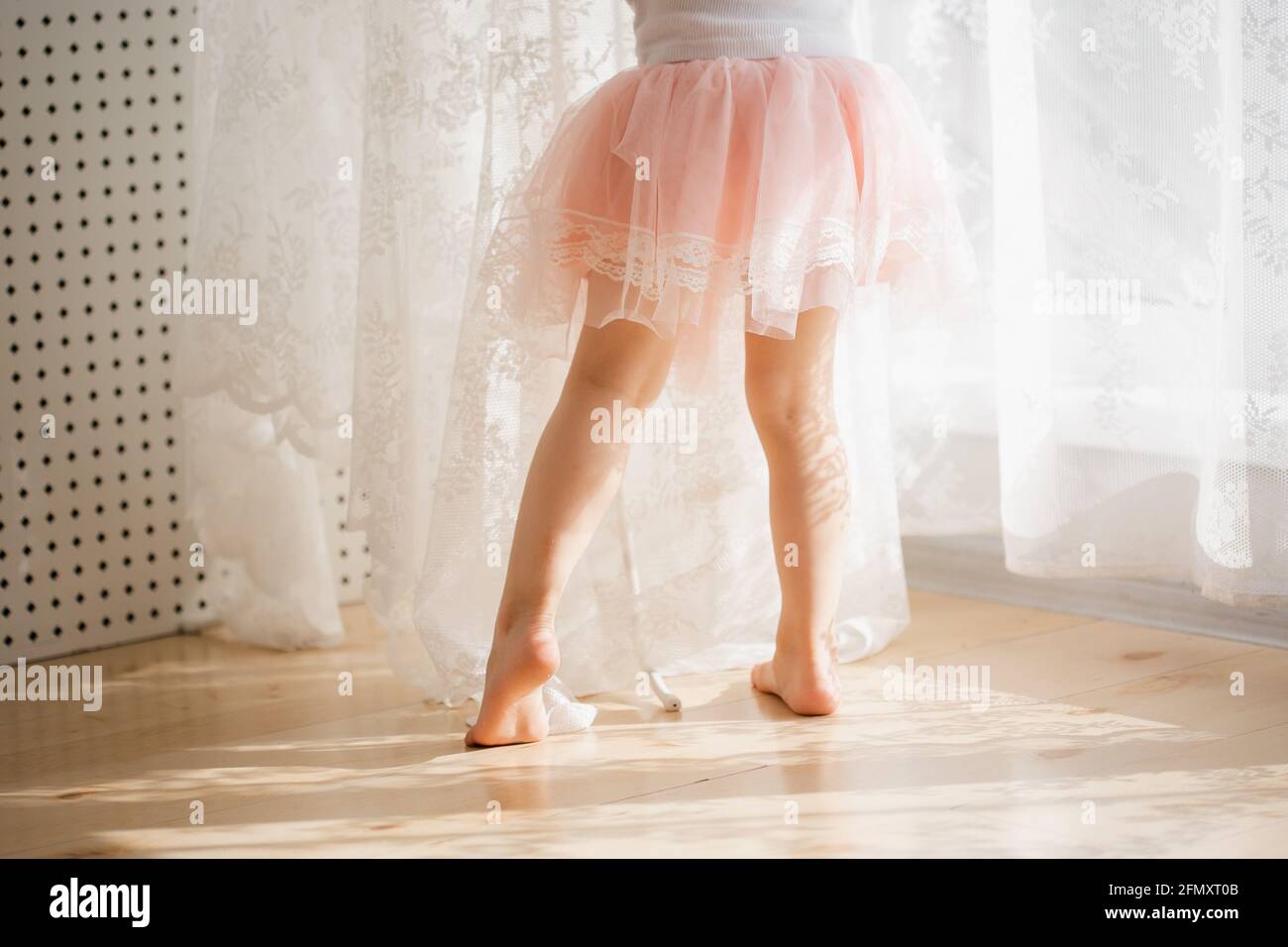 Cute little girl in a pink skirt. Beautiful sunshine Stock Photo - Alamy