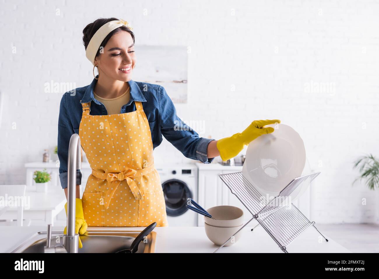 Woman putting apron on hi-res stock photography and images - Alamy
