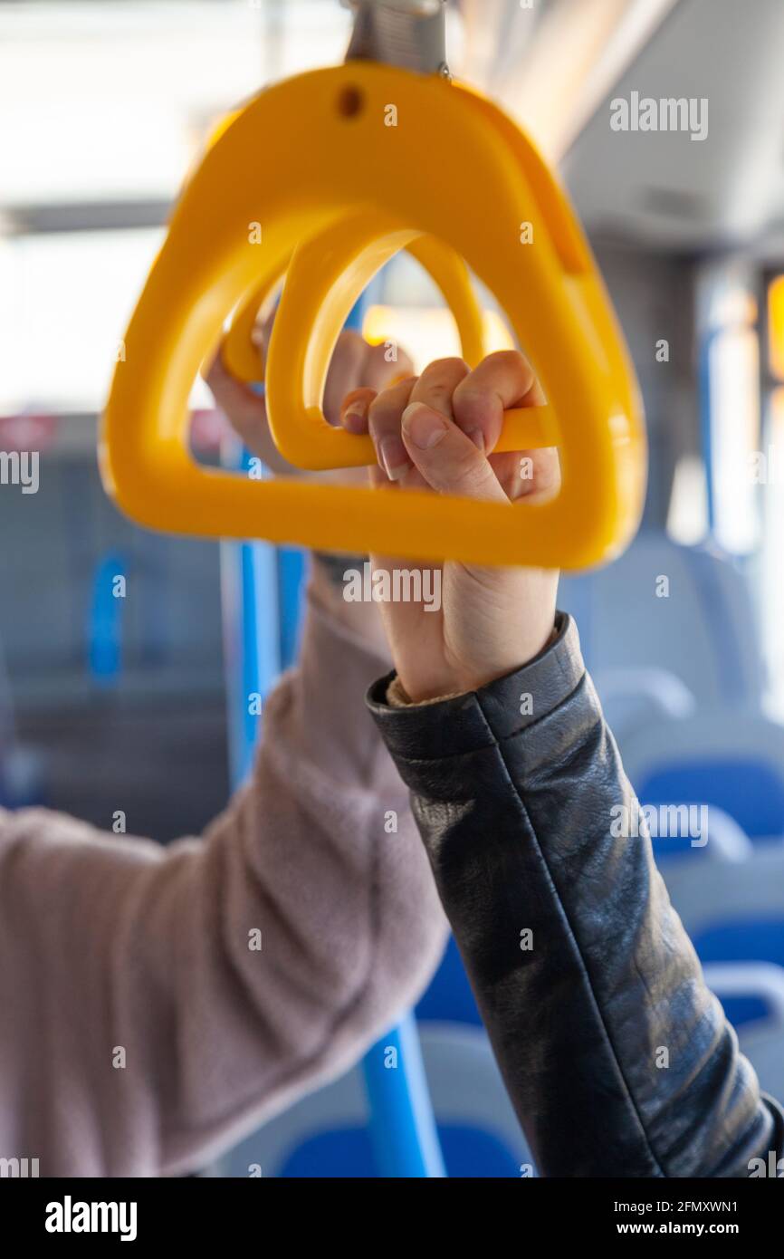 Hands holding bus handlebars Stock Photo Alamy