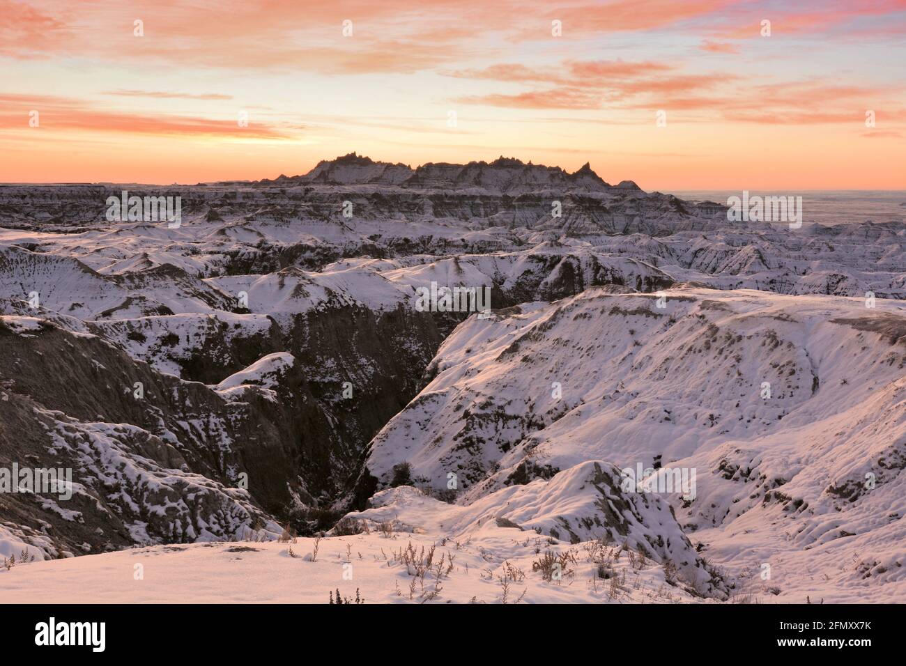Snow-covered spires and canyons greet the sunrise in the South Dakota badlands Stock Photo