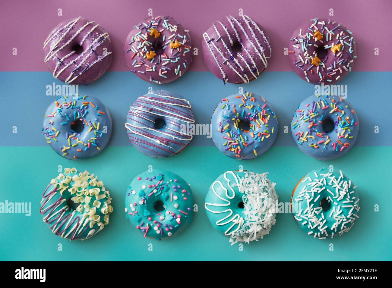 Colorful Donuts on striped pastel background Stock Photo
