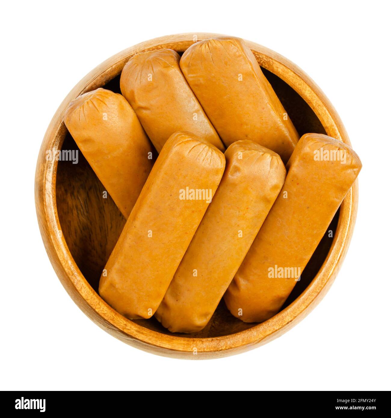 Vegan mini weenies, in a wooden bowl. Six small smoked sausages, made of saitan, a wheat gluten. Also called Wiener or Frankfurter Wuerstl. Close-up. Stock Photo
