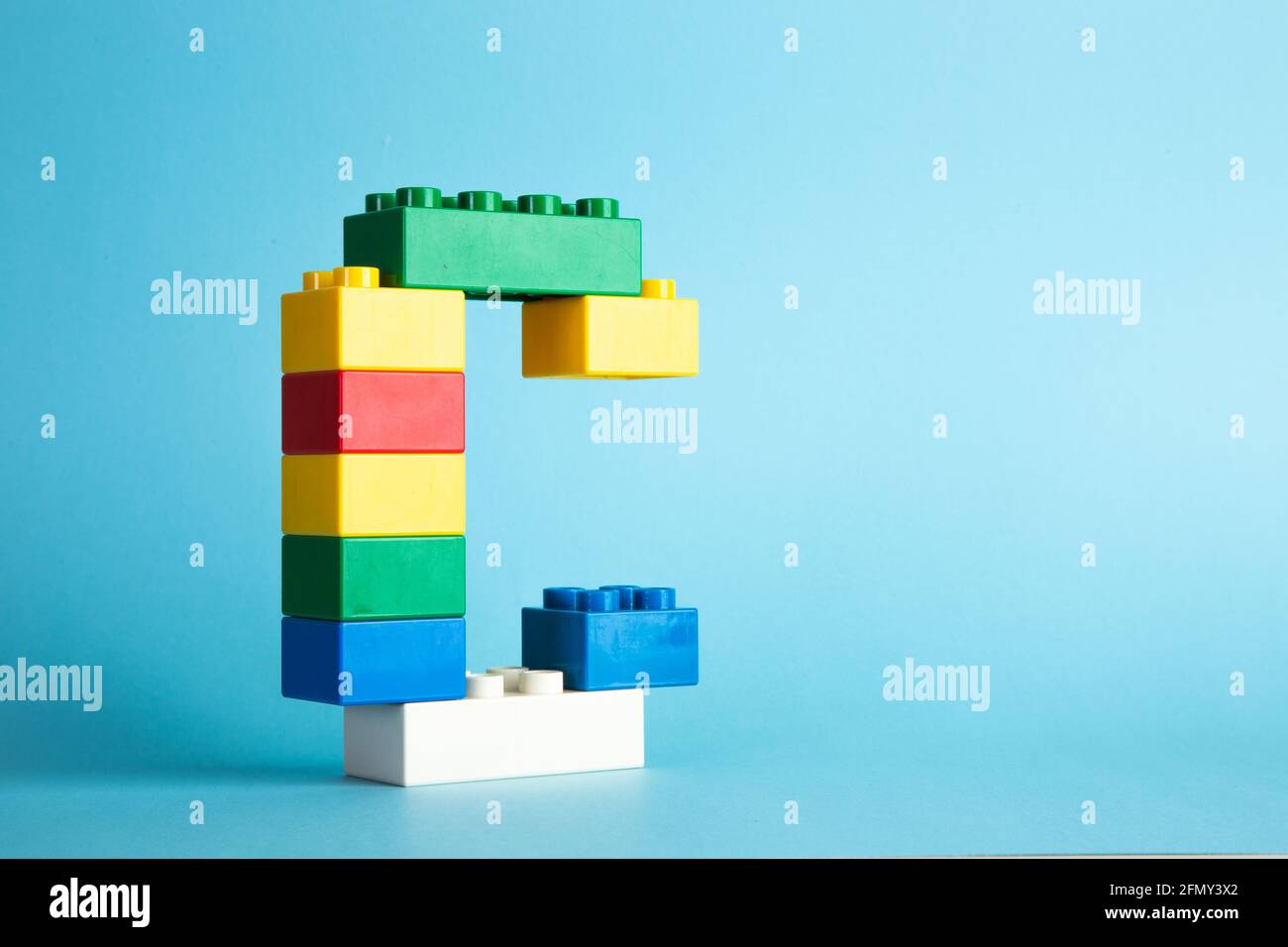 Plastic building blocks on blue background Stock Photo - Alamy