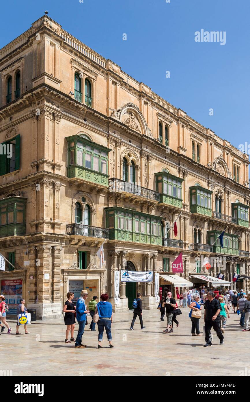 Pedestrian plaza with shops and traditional balconies, Valletta, Malta Stock Photo