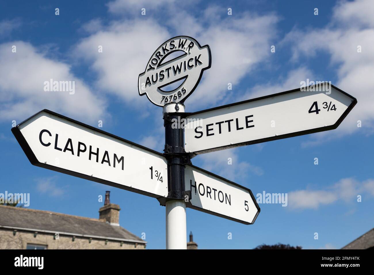 Signpost pointing to Clapham, Settle and Horton in Austwick, Yorkshire, UK Stock Photo