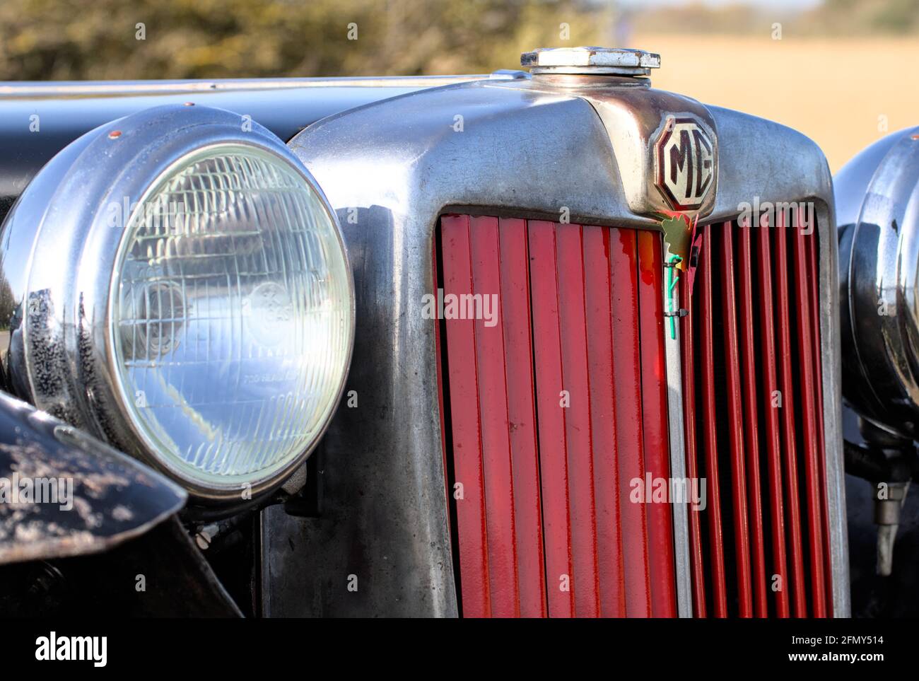 Front Of A 1936 MG Magnette N-Type Motor Car Showing Red Radiator Grill, MG Badge And Round Headlights, England UK Stock Photo