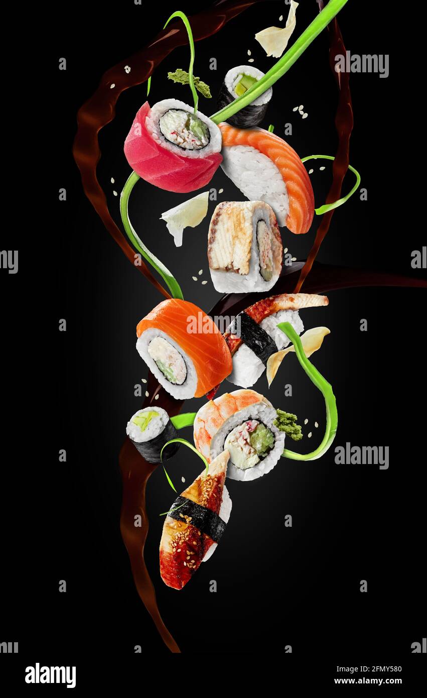 Assorted sushi with garnishes hovering in air on black background Stock Photo