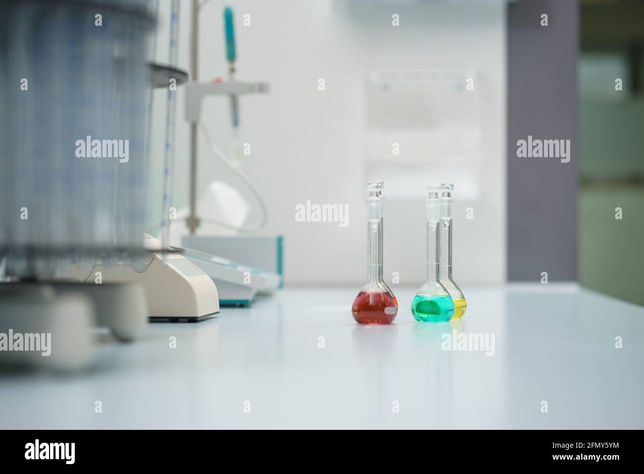 Test tubes and flasks with test liquid on the table in a chemical lab