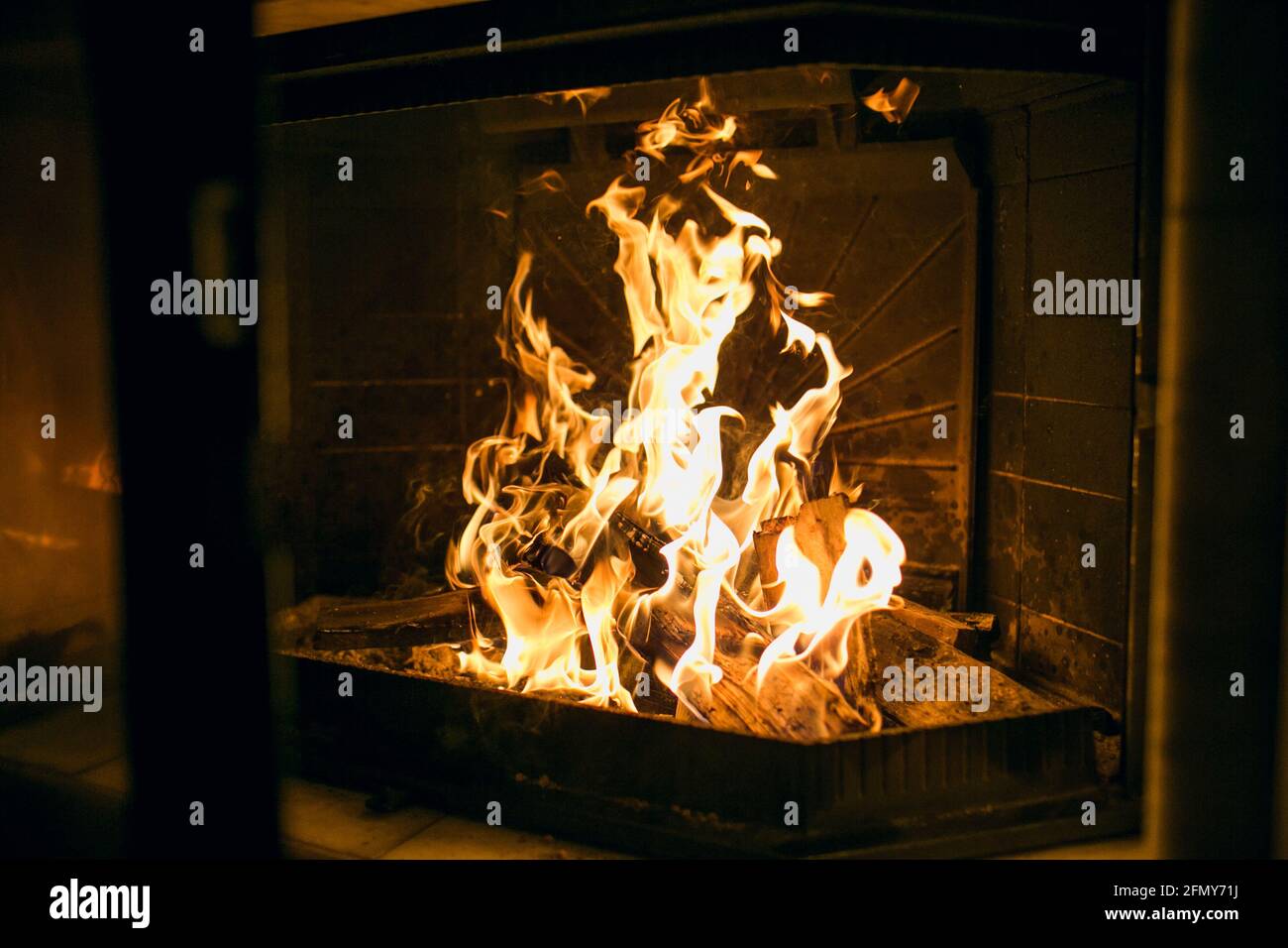 A fire burns in a fireplace, Fire to keep warm. Stock Photo