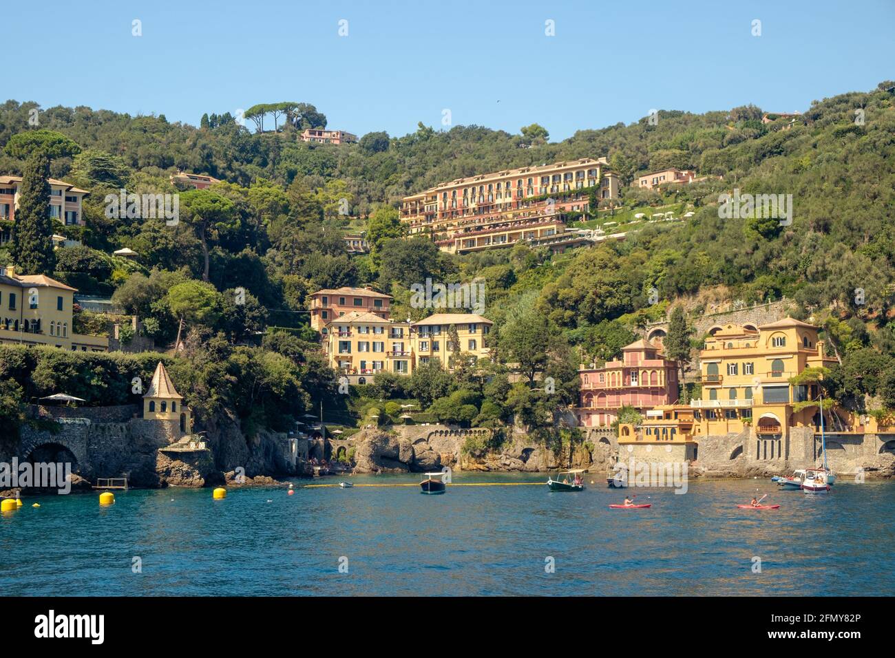 Hotels and other elegant buildings are built on a green hill that arises from the Ligurian sea. They are part of Santa Margherita Ligure. Stock Photo