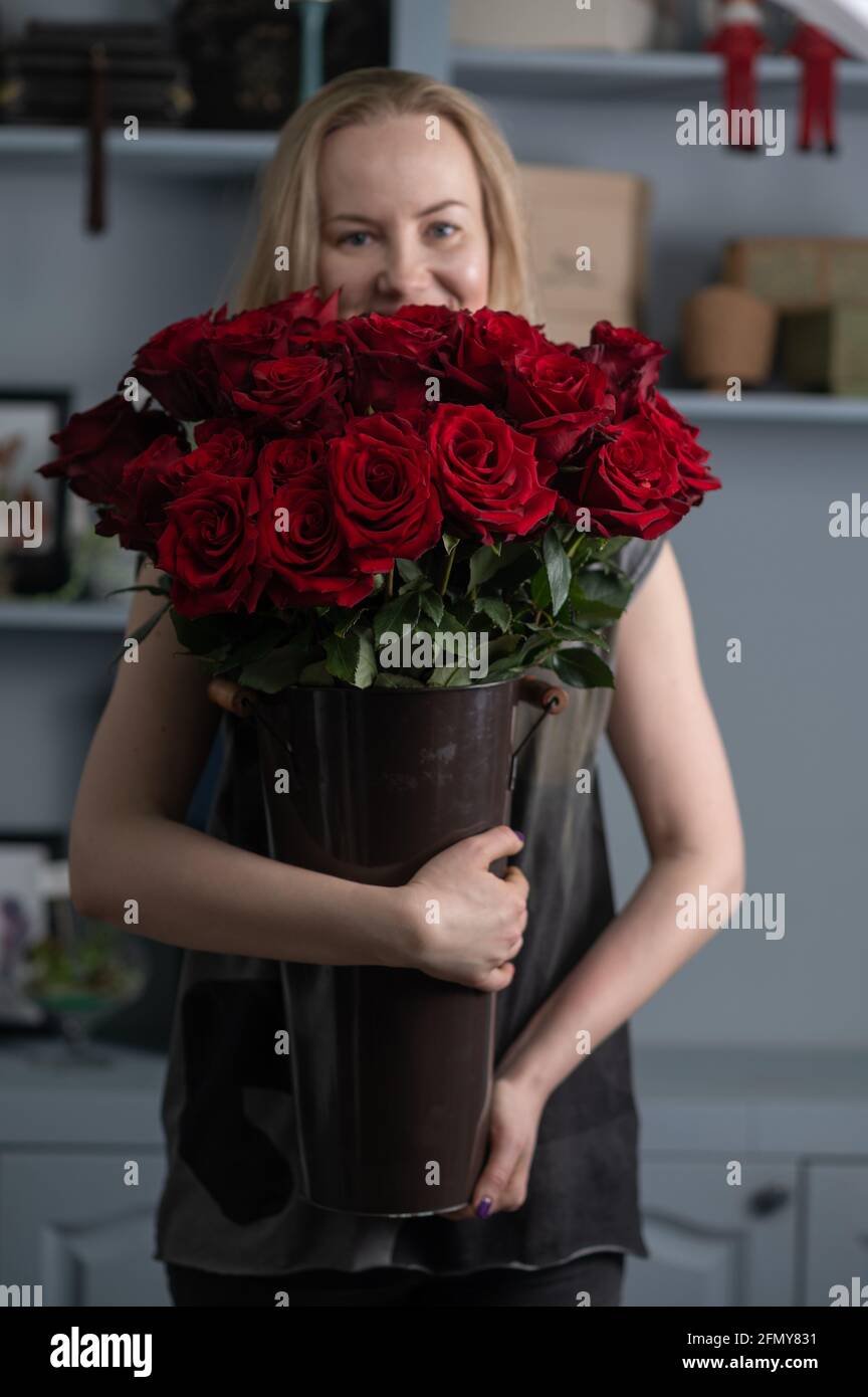 girl holding a huge bouquet of red roses in her hands Stock Photo - Alamy