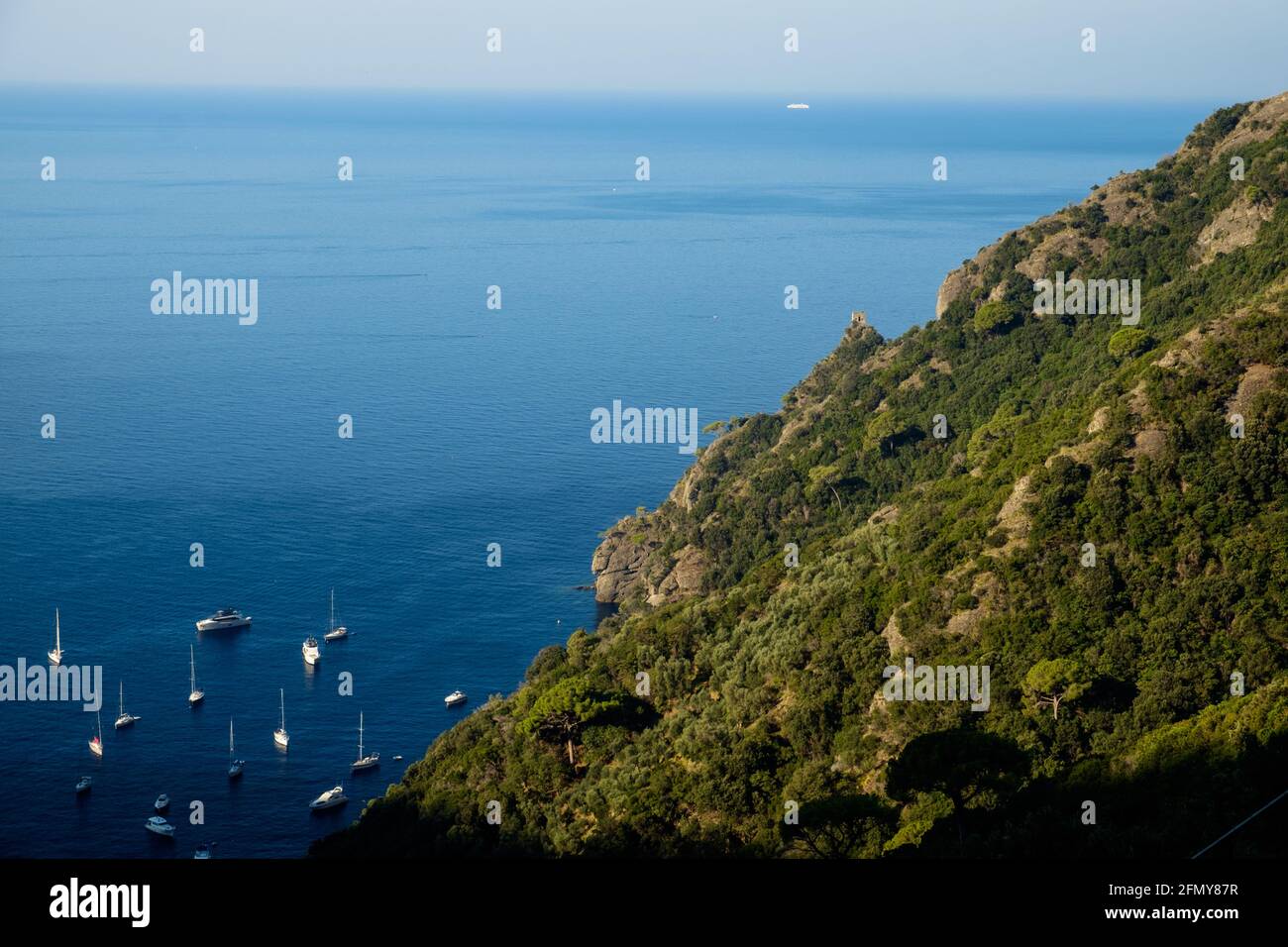 Panoramic view of San Fruttuoso bay, with small boats and clear blue water. Stock Photo