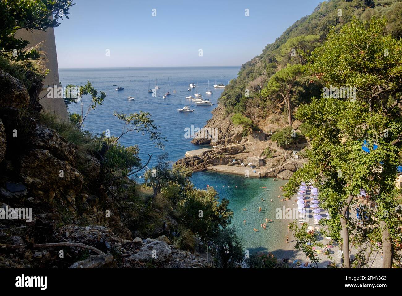 San Fruttuoso bay, with its small beach and hilly coastline. Entirely at the left, you see a part of Torre Doria. Stock Photo