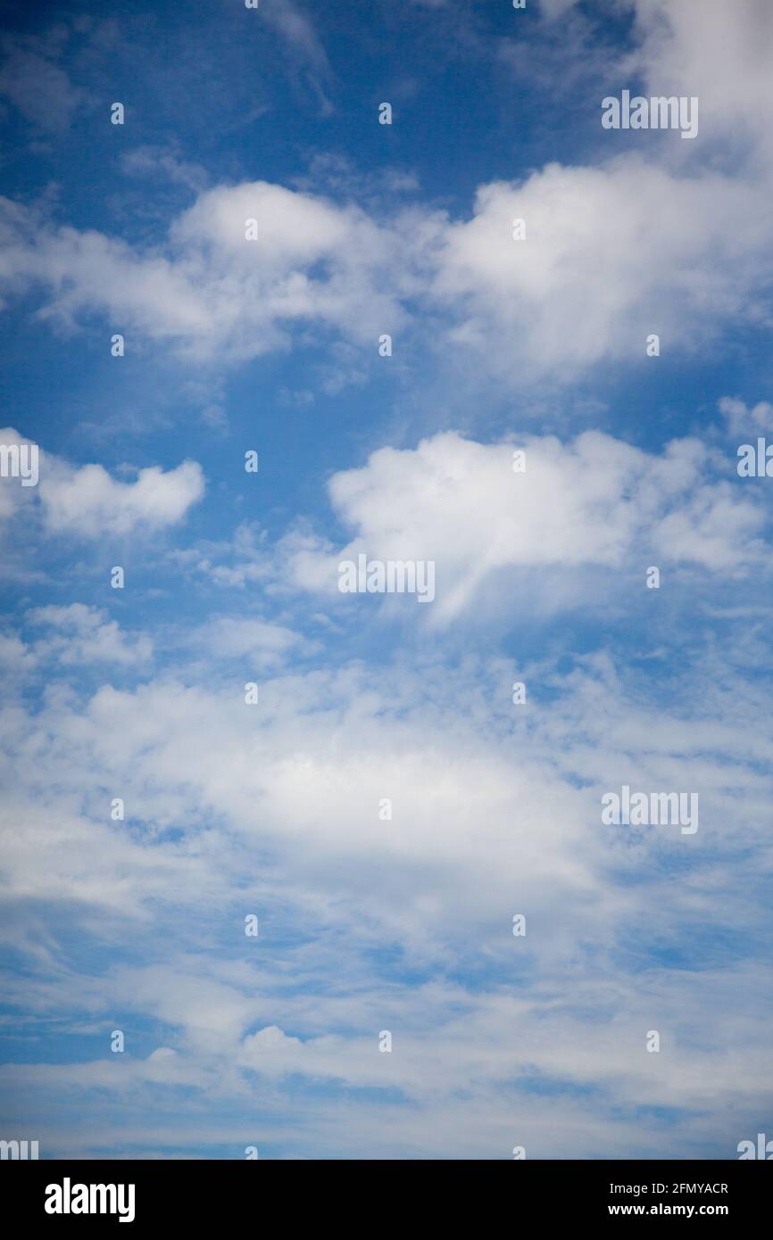 a sunny blue sky with fluffy white summer clouds suitable for use as a ...