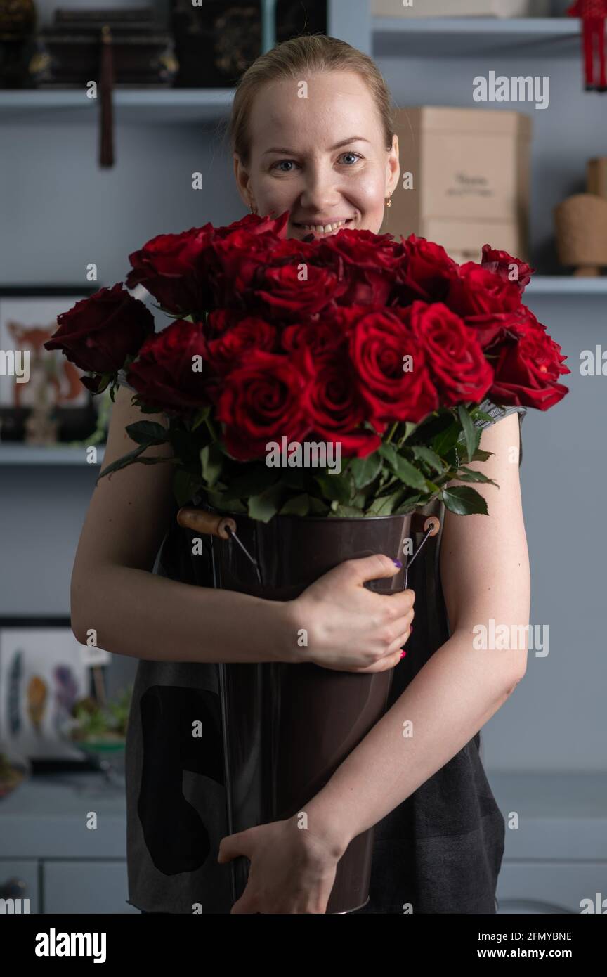 girl holding a huge bouquet of red roses in her hands Stock Photo - Alamy