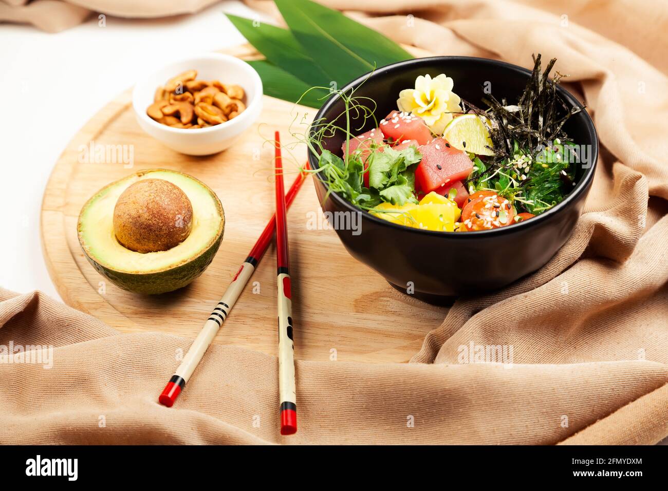 Poke salad with tuna in a bowl. Ingredients fresh tuna, cherry tomatoes