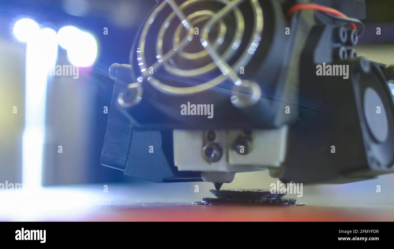 Modern 3D printer machine printing plastic model at exhibition - close up Stock Photo