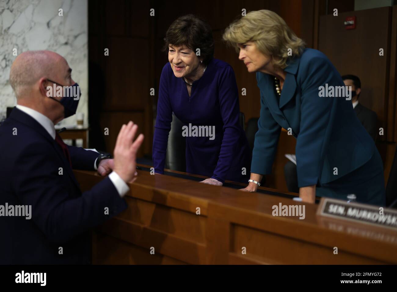 Washington, USA. 12th May, 2021. WASHINGTON, DC - MAY 12: U.S. Homeland Security Secretary Alejandro Mayorkas (L) talks to Sen. Susan Collins (R=ME) (2nd L) and Sen. Lisa Murkowski (R-AK) (R) during a break of a hearing before the Senate Appropriations Committee at Hart Senate Office Building on May 12, 2021 on Capitol Hill in Washington, DC. The committee held a hearing on “Domestic Violent Extremism in America.” (Photo by Alex Wong/Pool/Sipa USA) Credit: Sipa USA/Alamy Live News Stock Photo