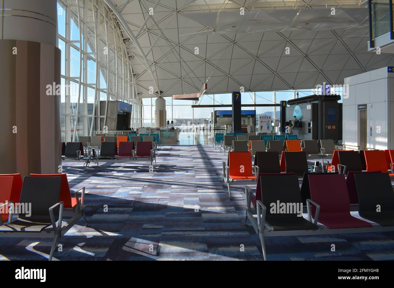 An almost empty terminal 1 at Hong Kong international airport. May 2021 covid restrictions mean very few passengers and flights. Stock Photo